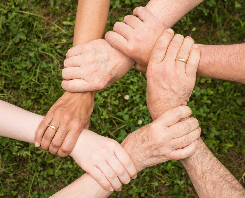 Six hands all connected to portray trust